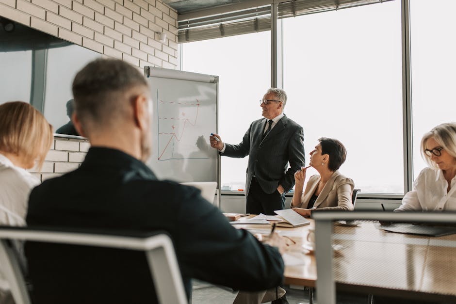 Senior leader presenting growth charts in a business meeting with colleagues in a modern office setting