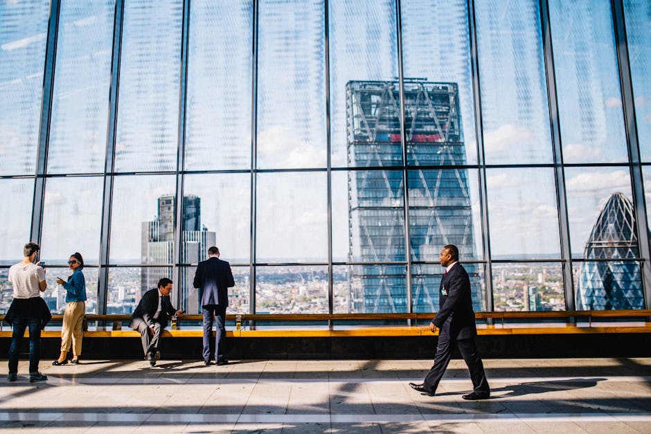 Business professionals in a modern office against a London skyline view