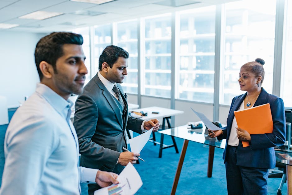 Business professionals discussing documents in a modern office environment