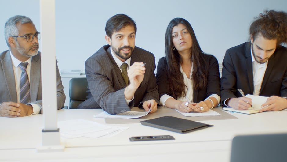 A diverse group of professionals in a modern office during a business meeting in Portugal