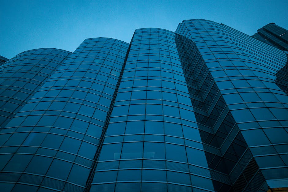 Low-angle shot of a modern skyscraper facade against the twilight sky