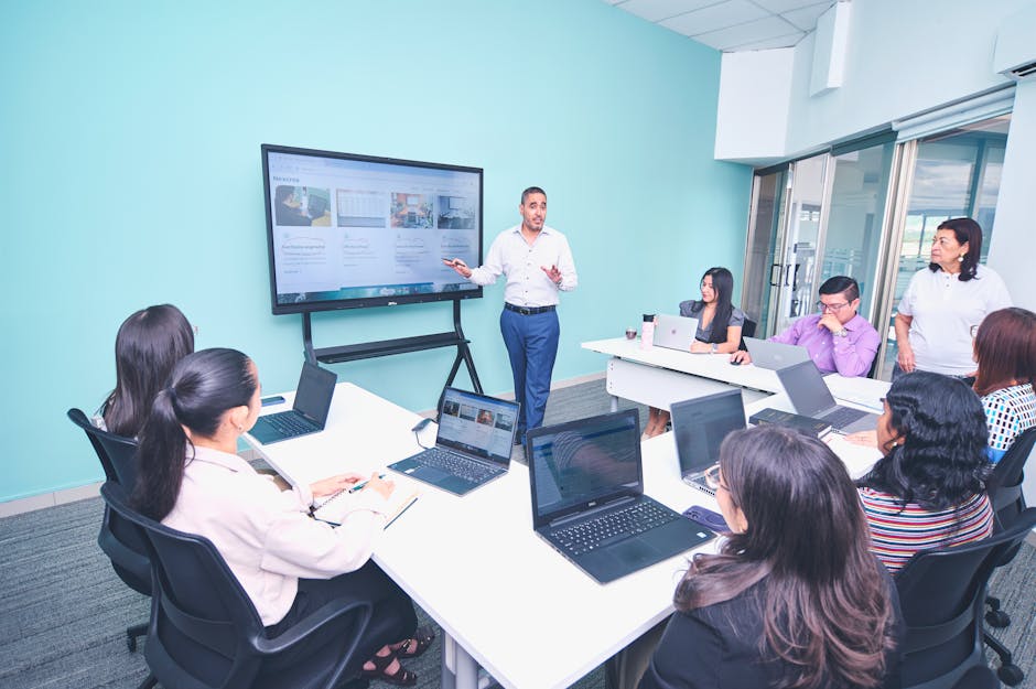 Team engaged in a presentation at a modern office using digital technology